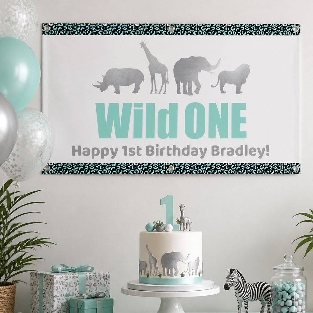 Aqua and silver Wild One first birthday setup with a personalised safari banner and matching cake