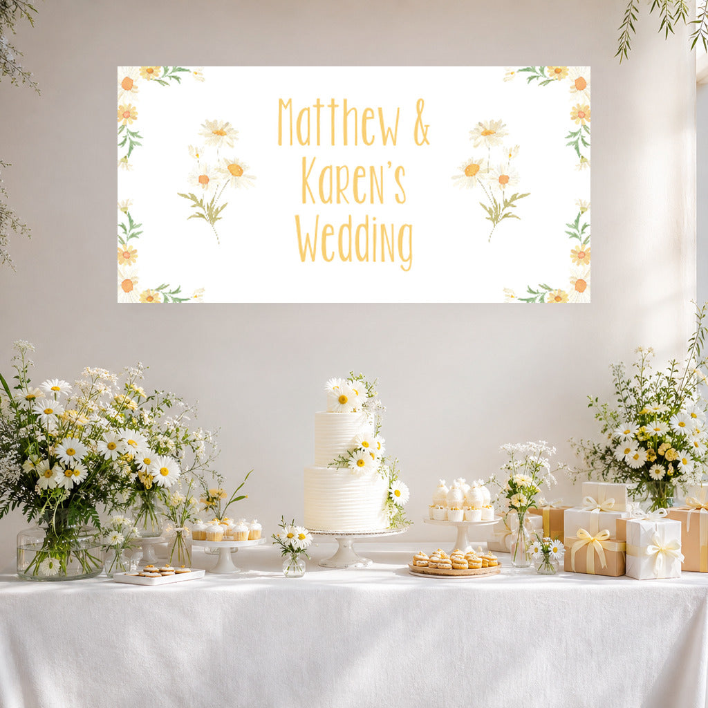 Daisy wedding dessert table with Matthew and Karen's personalised floral banner, white cake, daisies and cream decorations.