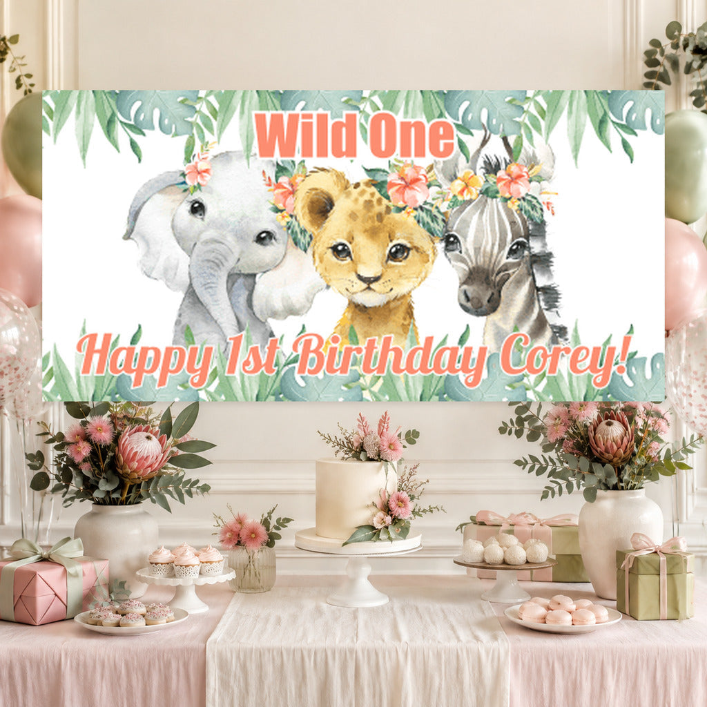 Floral African animals Wild One first birthday dessert table with Corey's personalised elephant, lion cub and zebra banner, cake, balloons and matching decorations.