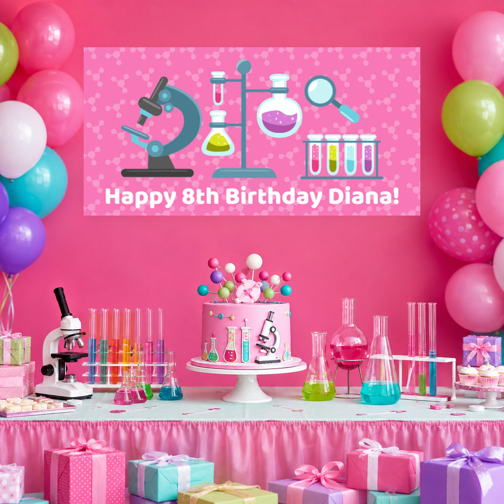 Girls science birthday dessert table with Diana's personalised pink banner, science cake, colourful balloons and laboratory-themed decorations.