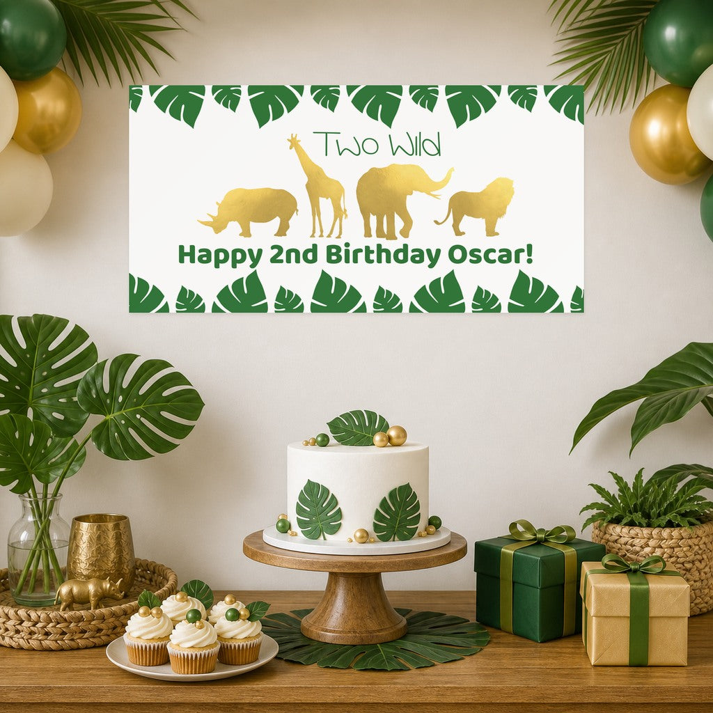 Gold Safari Two Wild second birthday decorations with Oscar's original personalised animal banner, a leaf-decorated cake, cupcakes, green and gold balloons and matching gifts.
