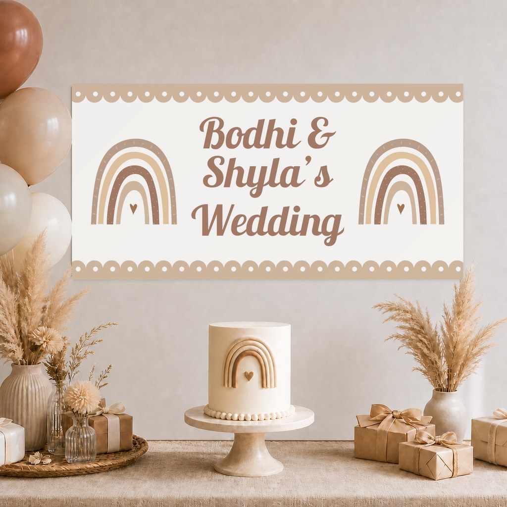 Neutral Boho Rainbow Wedding Decorations with a personalised banner, coordinated cake, coordinated rainbow artwork, soft florals and matching table styling.