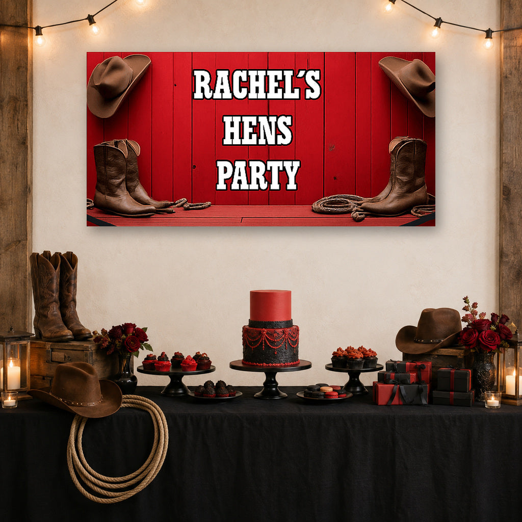 Red Western hens party dessert table with Rachel's personalised banner, cowboy hats, boots, rope, red cake and rustic decorations.