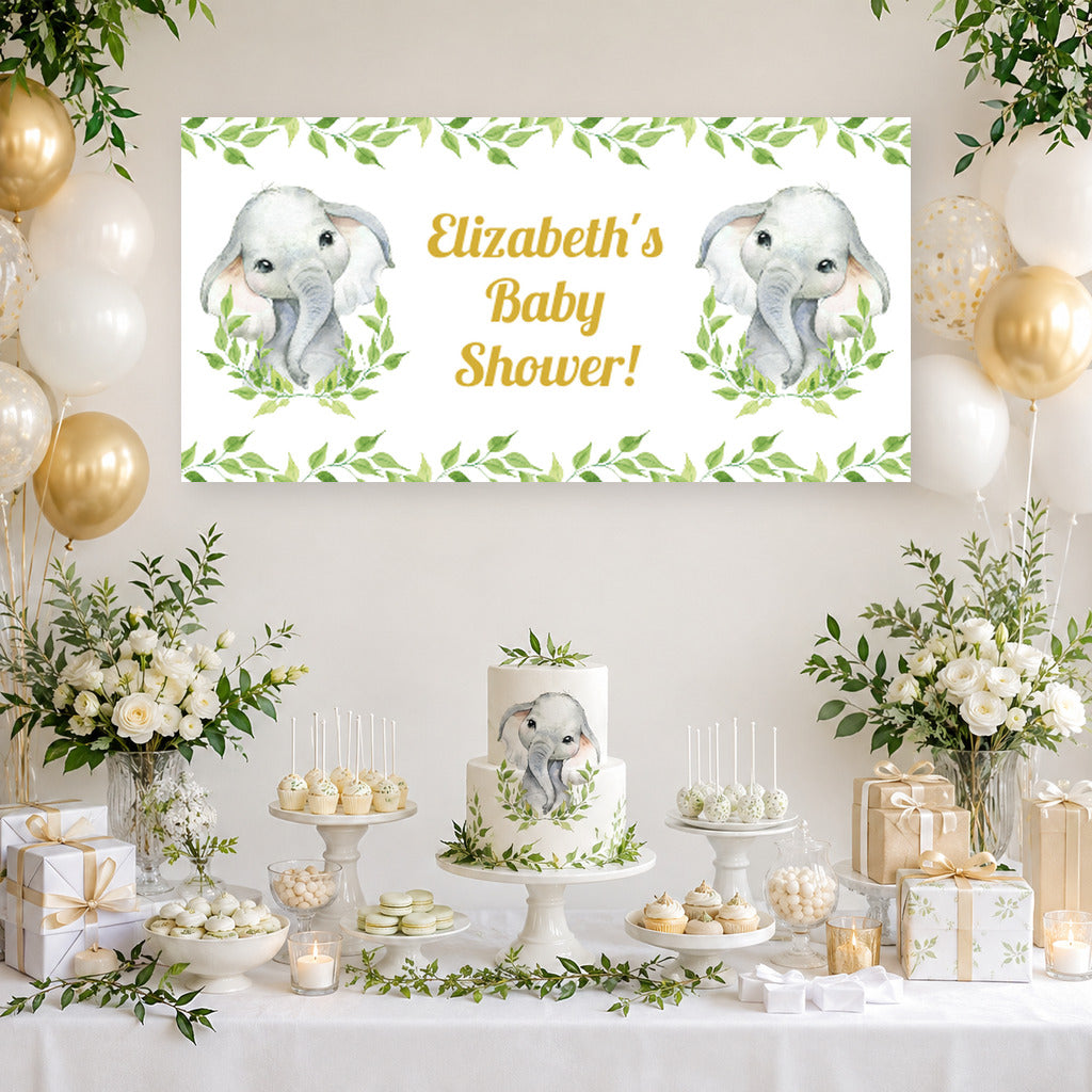 White greenery elephant baby shower dessert table with Elizabeth's personalised banner, cake, white and sage balloons and matching party decorations.