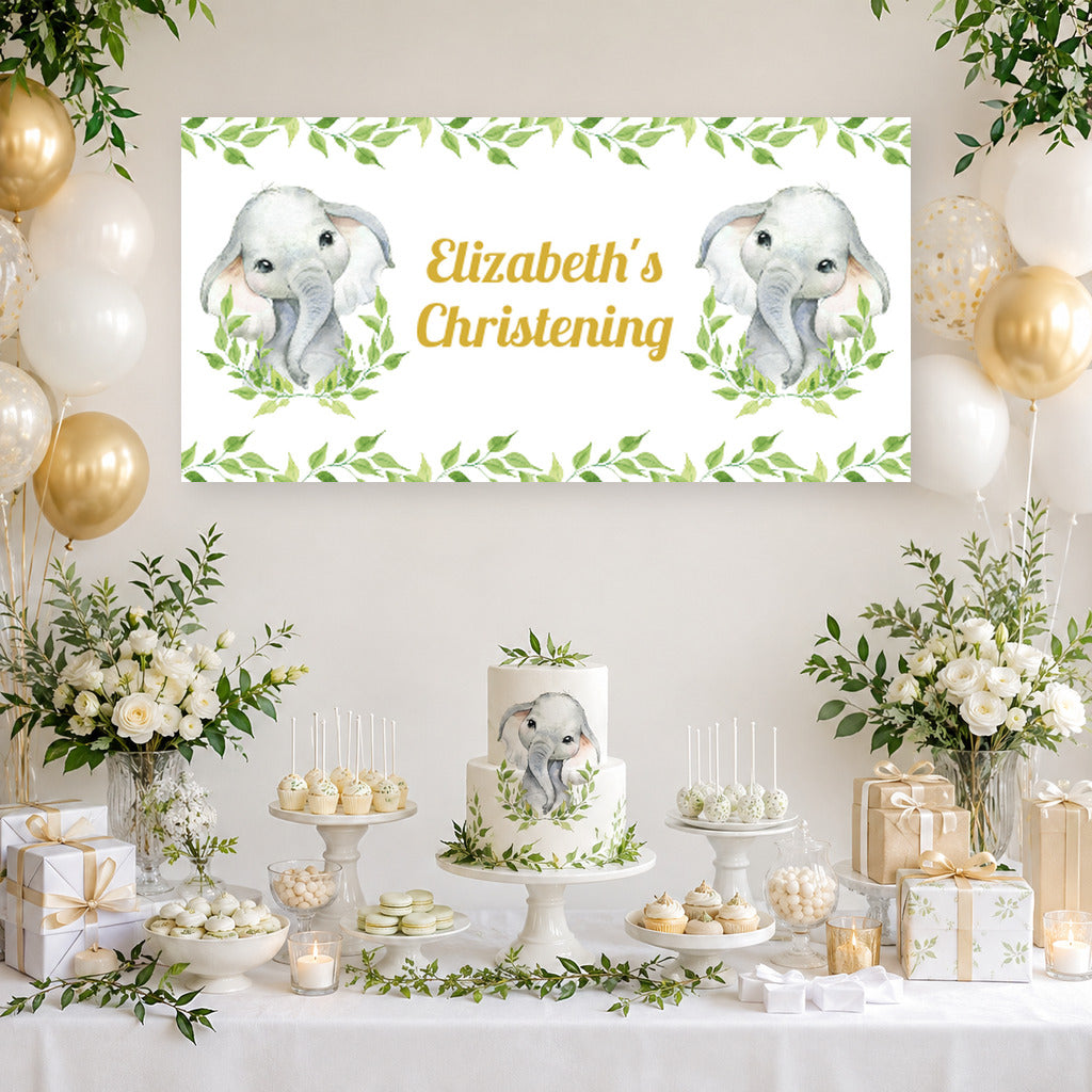 White greenery elephant christening dessert table with Elizabeth's personalised banner, cake, white and sage balloons and matching party decorations.