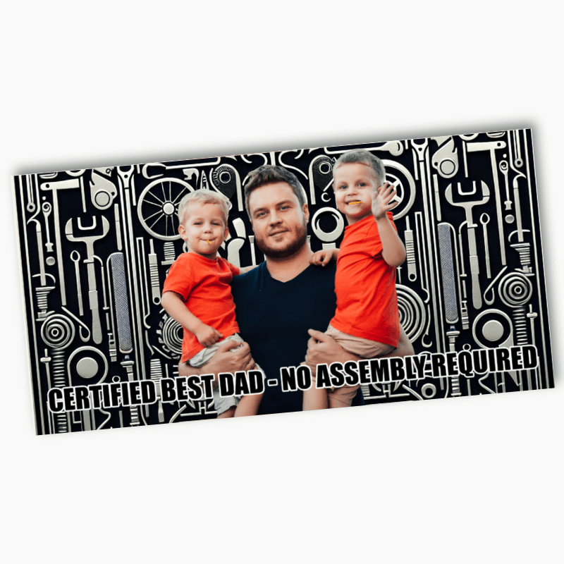 Father holding two children with a tool pattern background and text 'Certified Best Dad - No Assembly Required'.