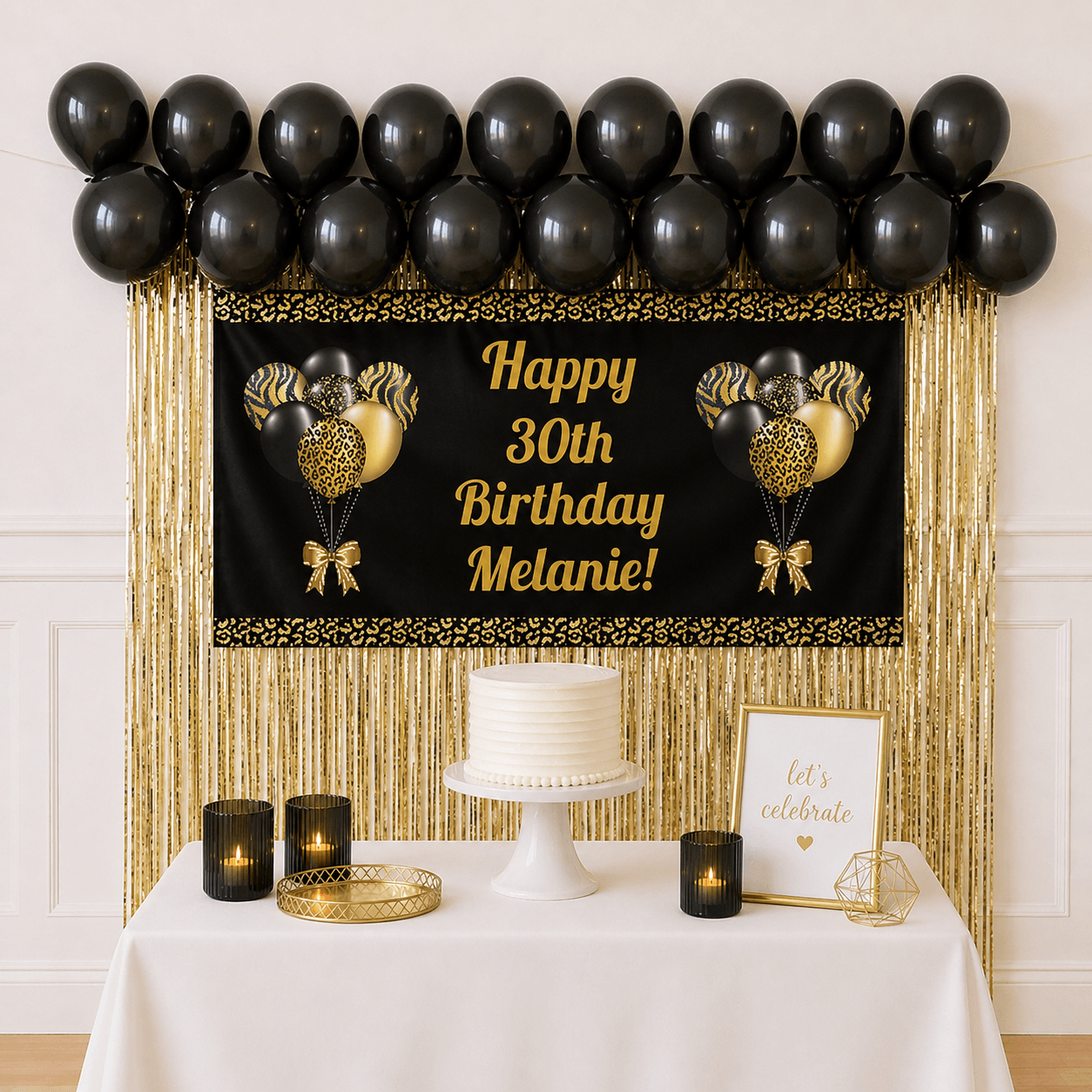 Black and gold celebration party package with personalised banner, black balloons and gold foil fringe curtains