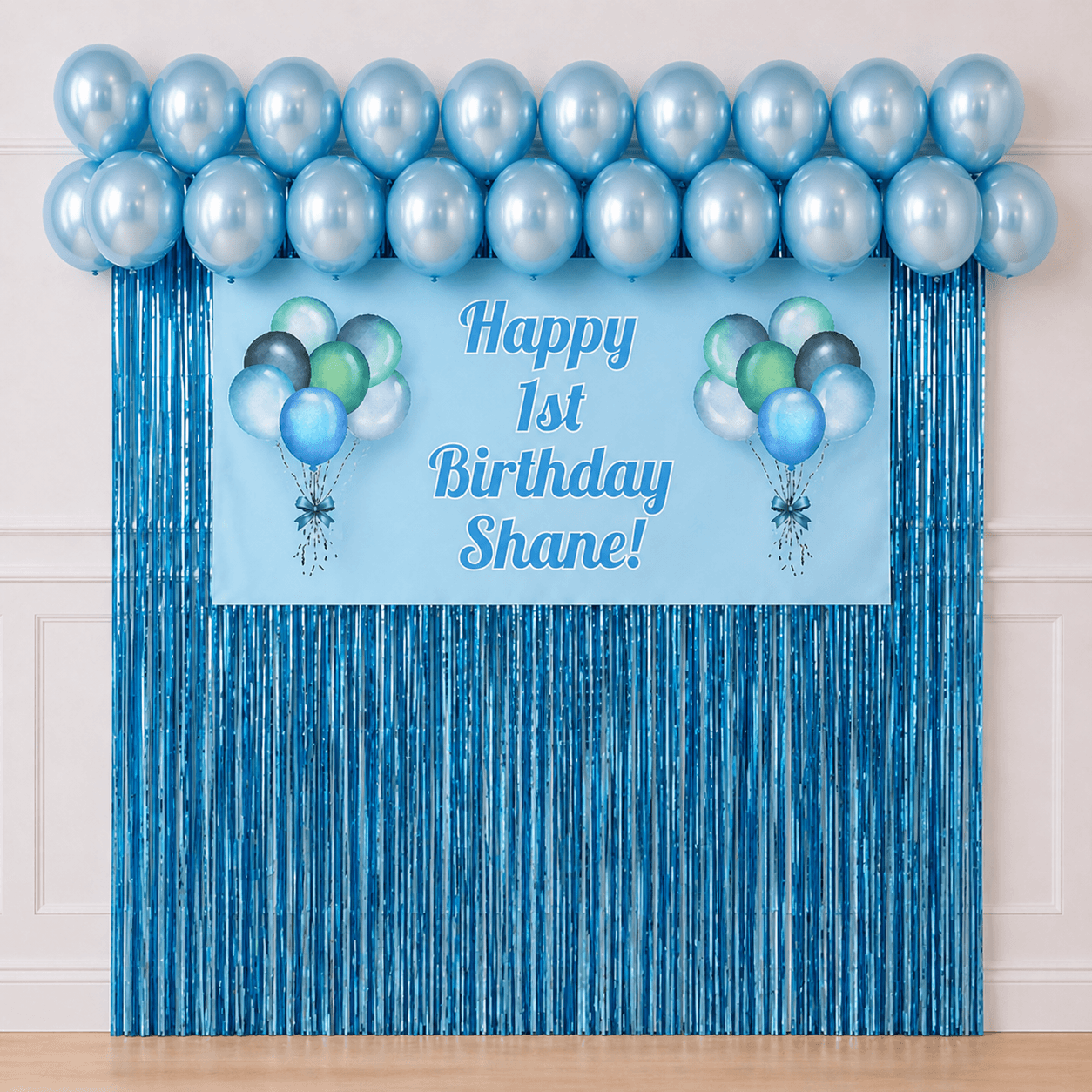 Personalised pastel blue celebration party package with custom text banner, pearl blue balloons and blue foil fringe curtains displayed as a completed party setup