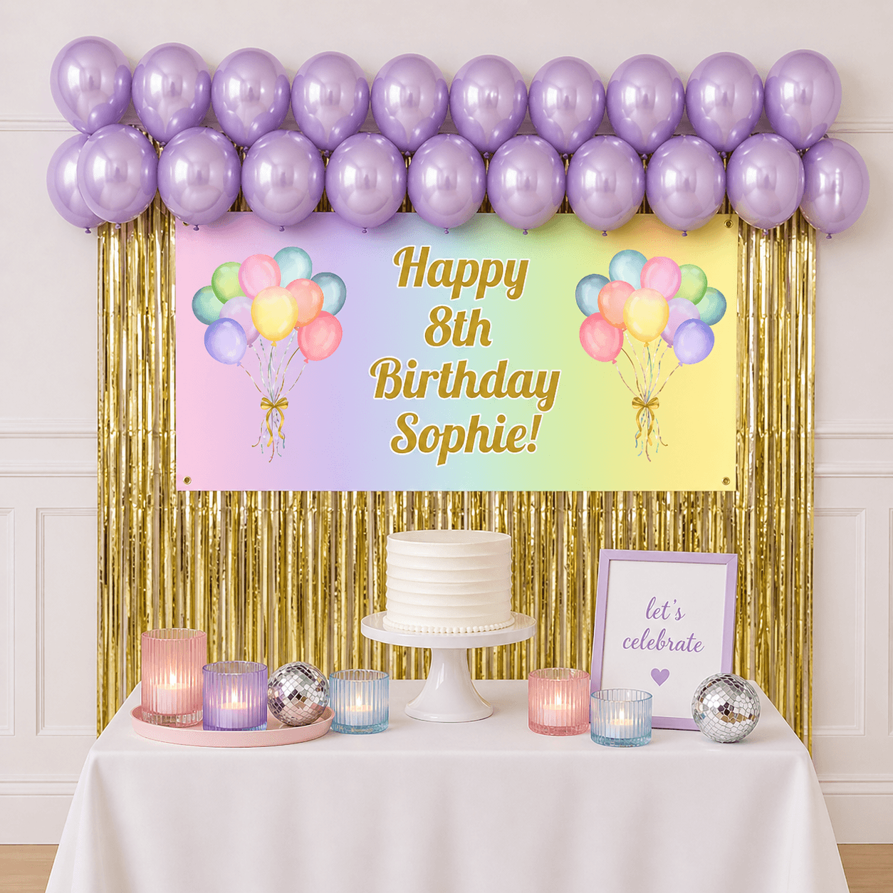 Personalised pastel rainbow celebration party package with custom text banner, pastel purple balloons and gold foil fringe curtains displayed as a completed party setup