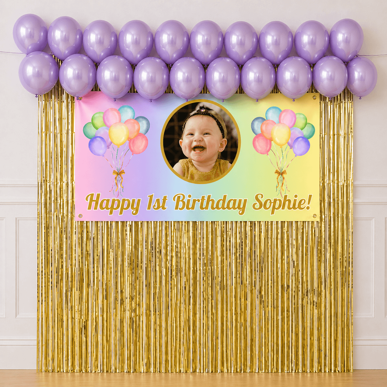 Personalised pastel rainbow celebration party package with photo banner, pastel purple balloons and gold foil fringe curtains displayed as a completed party setup