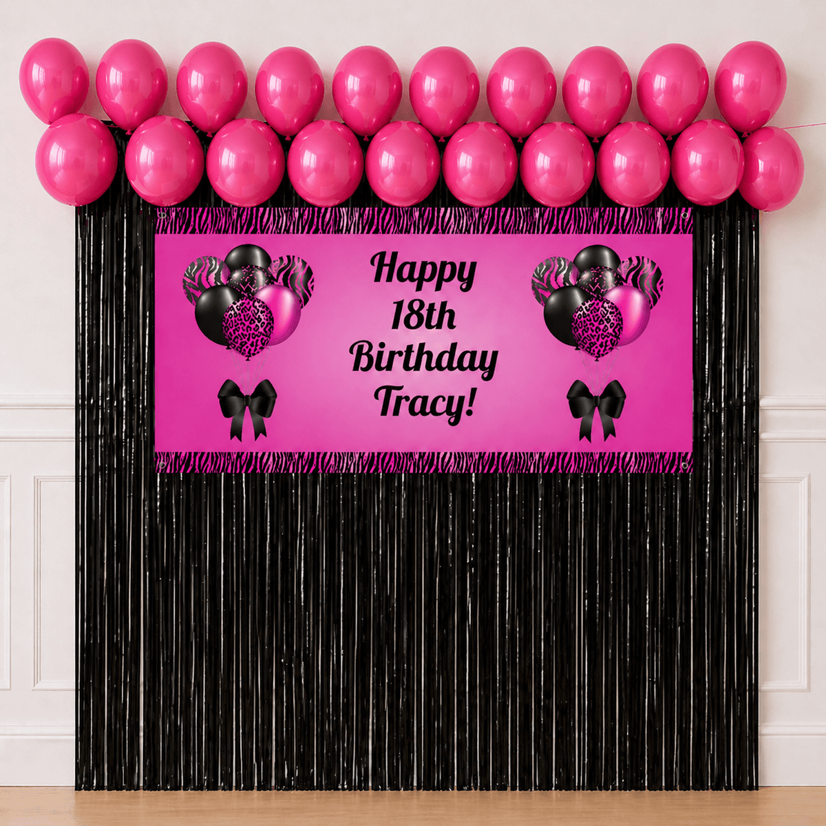 Pink and black celebration party package with personalised banner, hot pink balloons, black foil fringe curtains and hanging accessories on white background