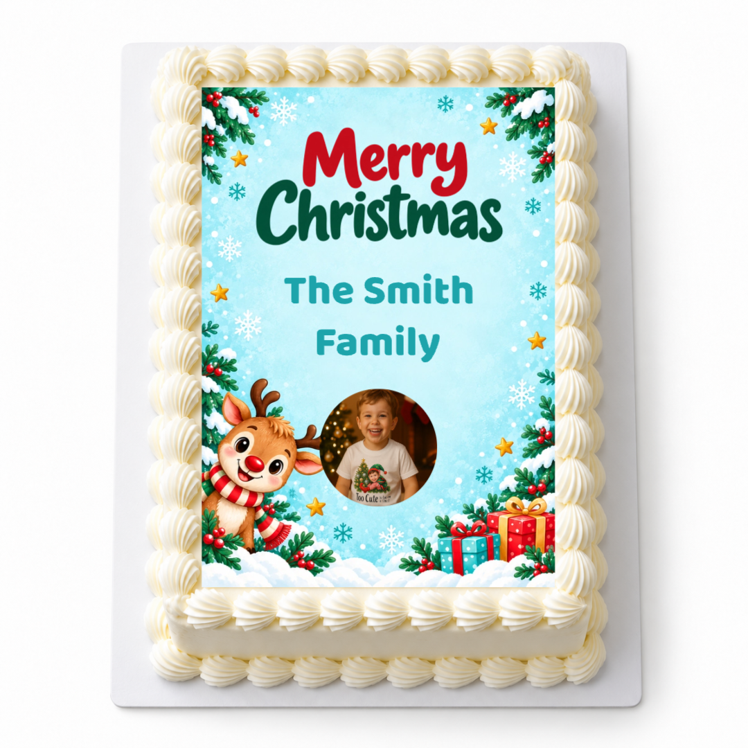 Rudolph Christmas A4 edible icing sheet with a child's photo, The Smith Family name and a reindeer on blue, shown on a rectangular cake.