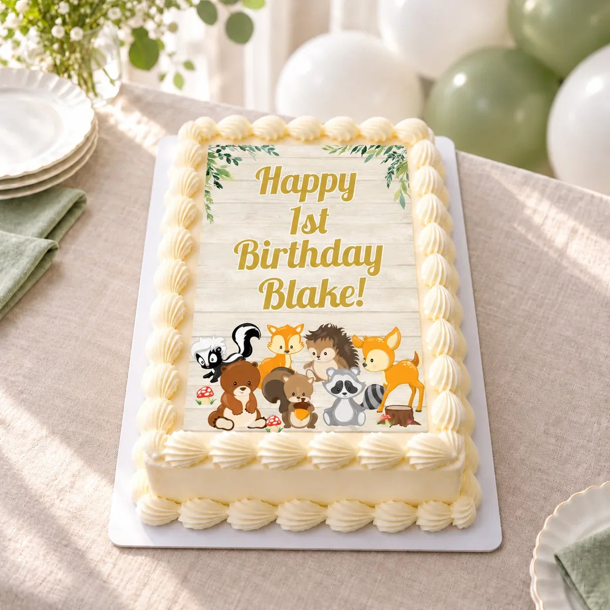 Woodland Animals A4 icing sheet fitted to a white cake with Happy 1st Birthday Blake wording