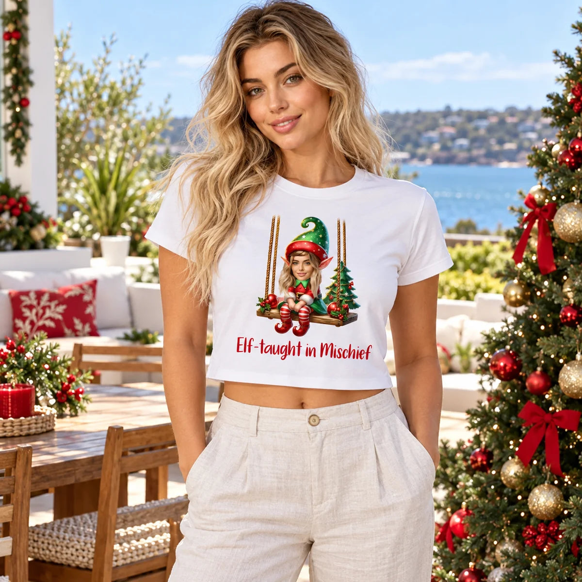 Woman wearing a personalised white Christmas crop top with Elf-taught in Mischief artwork featuring their matching face.